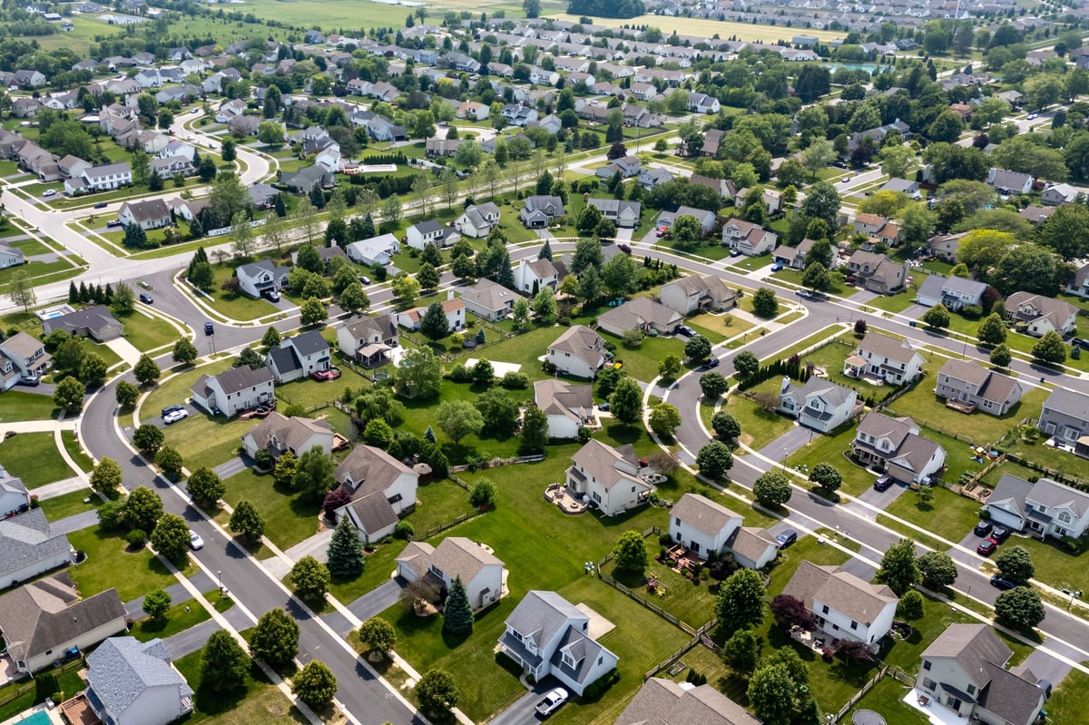 A suburban residential neighborhood with family houses and mature trees
